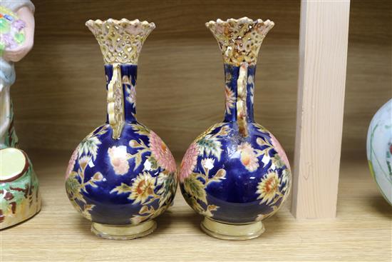 A pair of Zsolnay Pecs reticulated vases, floral-decorated on a blue ground and heightened in gilt height 20cm (a.f.)